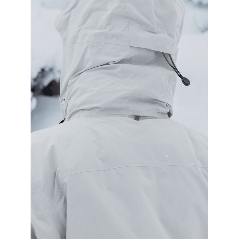 Close-up back view of a light gray Burton AK Lz Gore-Tex jacket featuring an adjustable hood with a cinch cord.