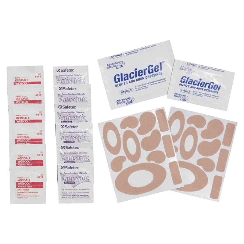 Contents laid out of the Adventure Medical Blister Kit showing blister packs, glacier gell dressing, antiseptic wipes.