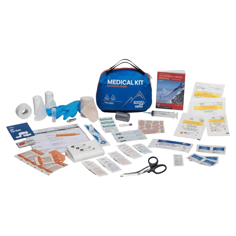 Contents laid out of the Adventure Medical Kits Explorer First Aid Kit showing the carry pouch, gloves, scissors, bandages, manual, tweezers, wipes etc.