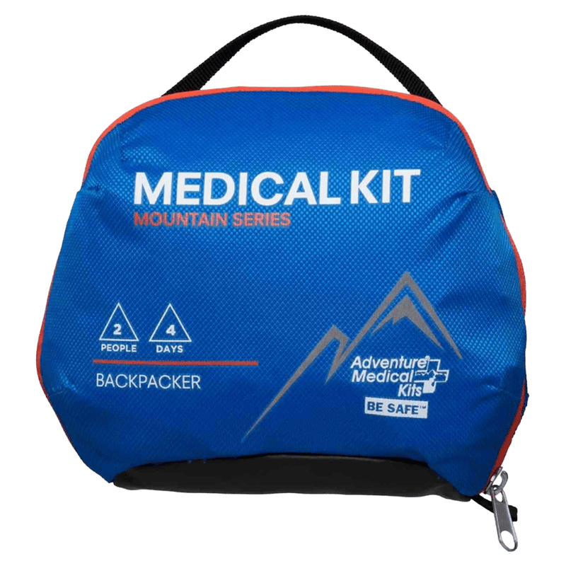 Front view of the Adventure Medical Backpacker Kit Case in blue with white writing and mountain logo. black strap handle.
