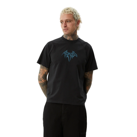 Worn view of Afends Bats Recycled Raglan Boxy Fit Tee in stone black