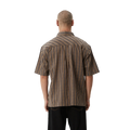 Back view of men wearing Afends Hometown Short Sleeve Shirt in coffee colorway