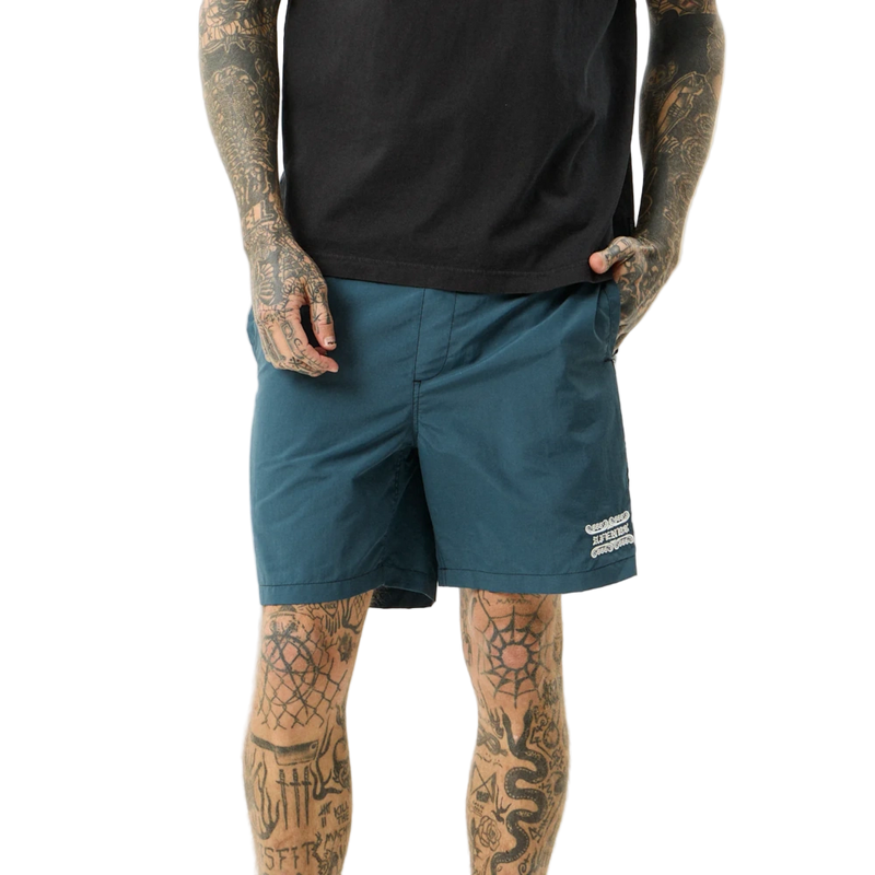 Man wearing Afends Sixsixsix Recycled Baywatch Shorts in fuel colorway