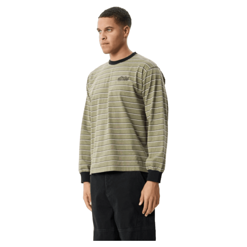 Side view of Afends Altitude Recycled Boxy Long Sleeve Tee in colour Stone Stripe.