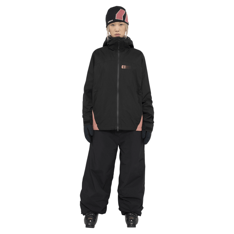 Full-body view of the Armade Ansel 2L Shell Jacket in Black and Faded Rose colourway, unisex's model