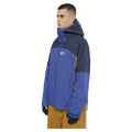 Side view of the Armade Ansel 2L Shell Jacket in Dazzler, Navy and Golden Brown colourway, unisex's model