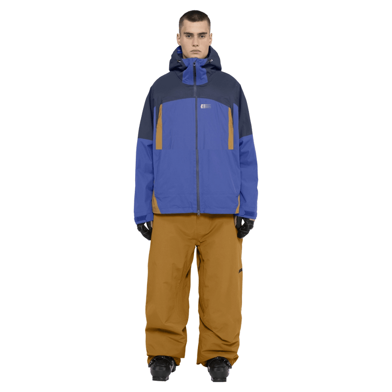 Full-body view of the Armade Ansel 2L Shell Jacket in Dazzler, Navy and Golden Brown colourway, unisex's model