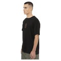 Side view of the Armada Icon Tee in Black colourway, unisex's model