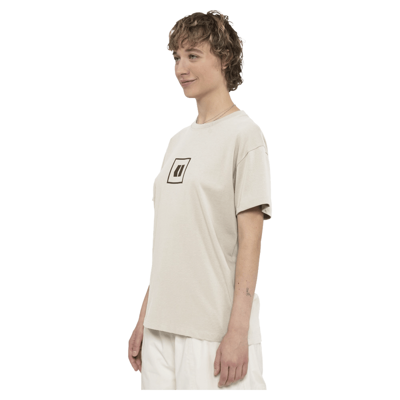 Side view of the Armada Icon Tee in Cream colourway, unisex's model