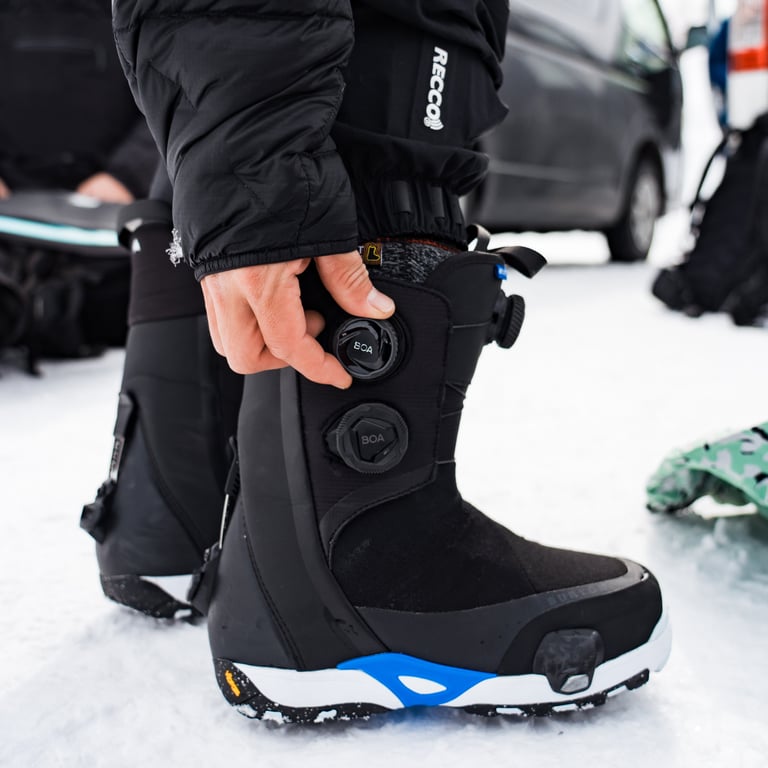 Person wearing Burton Highshot Step On Snowboard Boots - Womens tightening the BOA