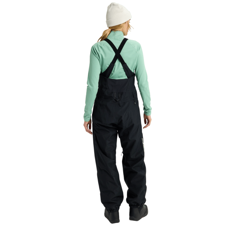 Back view of black Burton Reserve Bib Snowboard Pants for women with adjustable cross-back straps and a relaxed fit.
