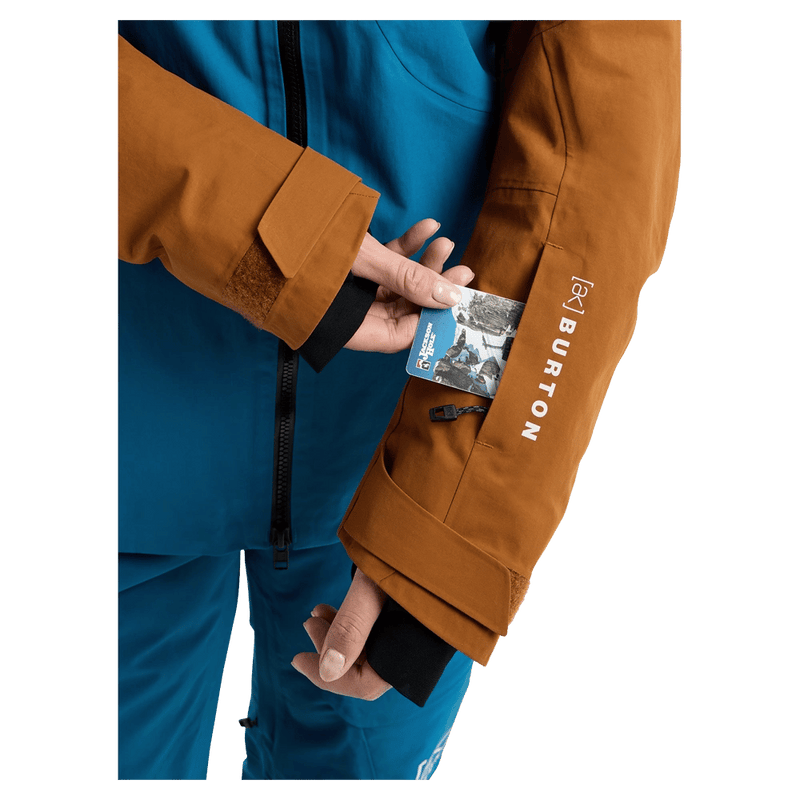 Pass pocket view of the Burton AK Embark Snowboard Jacket in Blue Teal and Chestnut colourway, women's model
