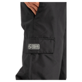 Pocket view of the DC Docile BIB in Black colourway, unisex model