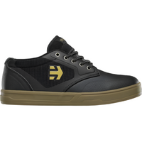 Black mountain bike shoe with brown sole and yellow logo.