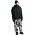 Black Burton Futuretrust 3L Snowboard Jacket with large diagonal zippers and hood, worn by a model in a full-body view.