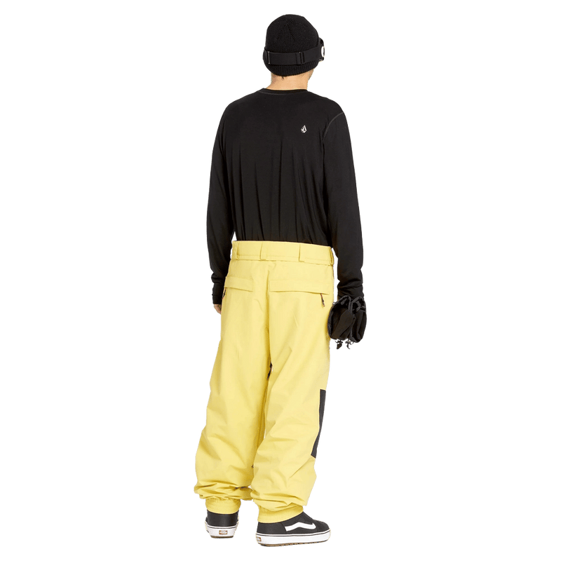 Rear view of yellow Volcom Longo Gore-Tex baggy snowboard pants with a relaxed fit and back pockets.