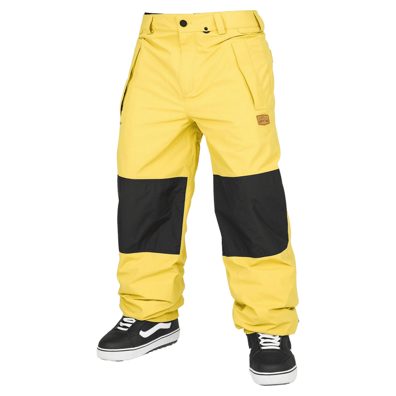 Yellow Volcom Longo Gore-Tex snowboard pants with black knee patches and a small logo patch, front view.