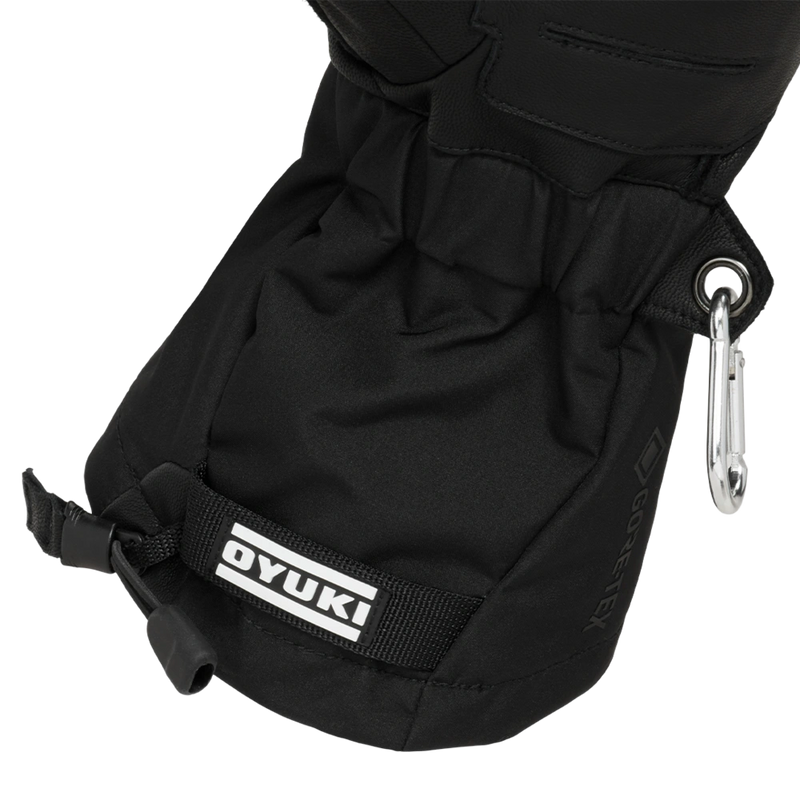 Detail view of the inner cuffs on the Arashi Guide Gtx Mitts in Black. Featuring a tunnelled elastic wrist cinch, toggle cuff adjustment, carabiner loop with silver carabiner, and contrast white logo.