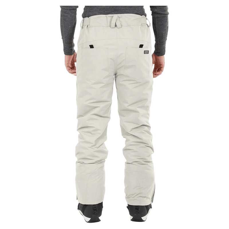 Rear view of light grey XTM Glide Ski Pants with belt loops and back pockets, worn with black ski boots.