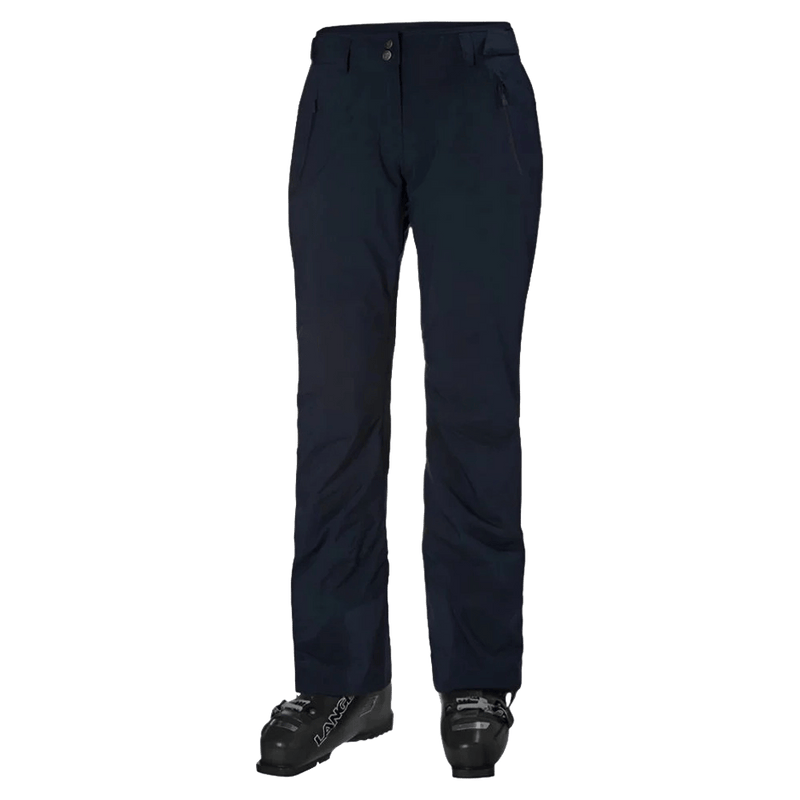 Navy blue Helly Hansen Legendary insulated women's ski pants with zippered pockets, shown from the front with ski boots.