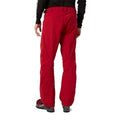 Red Helly Hansen Legendary Insulated Ski Pants, rear view, worn with ski boots.