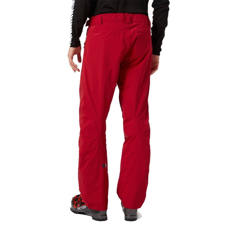 Red Helly Hansen Legendary Insulated Ski Pants, rear view, worn with ski boots.