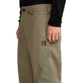 Olive green Volcom Kleveland Snowboard Pants with a side logo patch, belt loops, and contrasting leg panels.