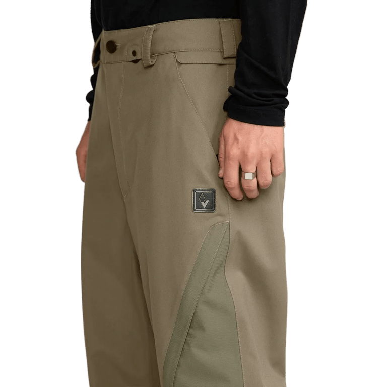Olive green Volcom Kleveland Snowboard Pants with a side logo patch, belt loops, and contrasting leg panels.