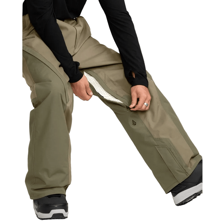 Volcom Kleveland olive green snowboard pants with an open mesh-lined inner thigh zipper vent for ventilation.