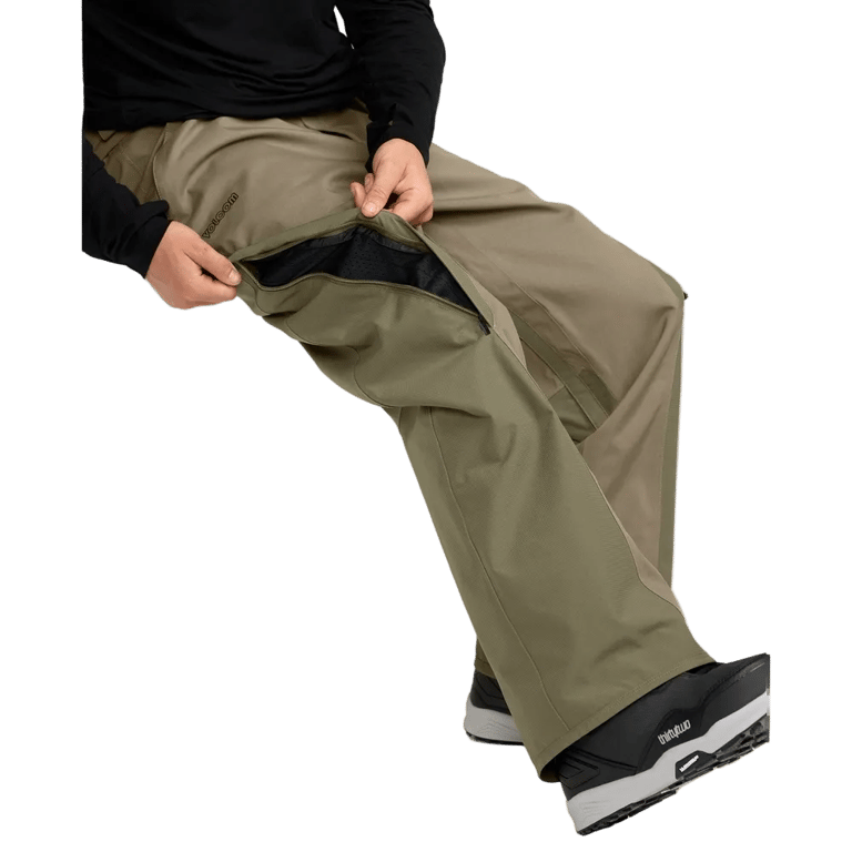 Olive green Volcom Kleveland snowboard pants with a zippered mesh-lined inner thigh vent for airflow.