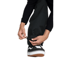 Close-up of black Volcom Longo Gore-Tex snowboard pants showing the adjustable elastic bungee cinch at the ankle.