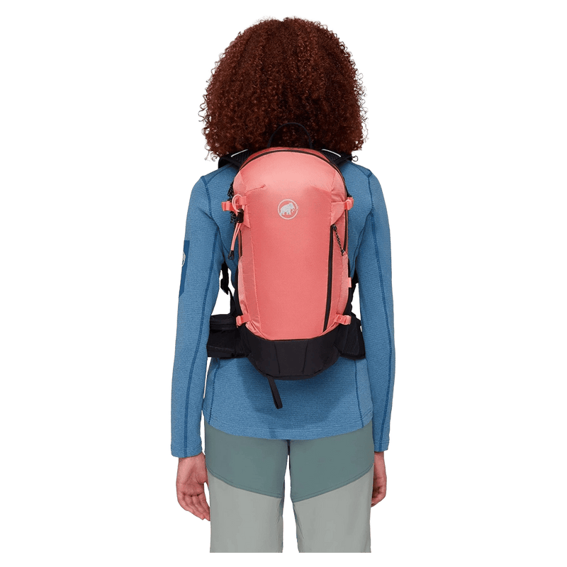 Carried view of the Mamut Lithium 15 Backpack in Salmon Black colourway, women's model