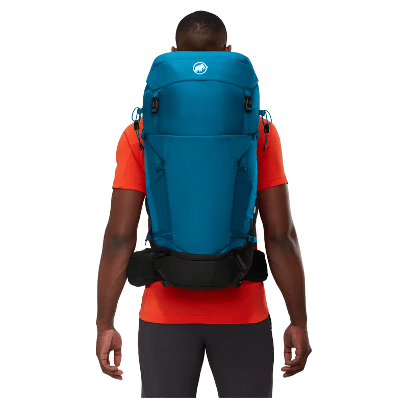 Carried view of the Mamut Lithium 40L Backpack in Sapphire Black colourway, unisex's model