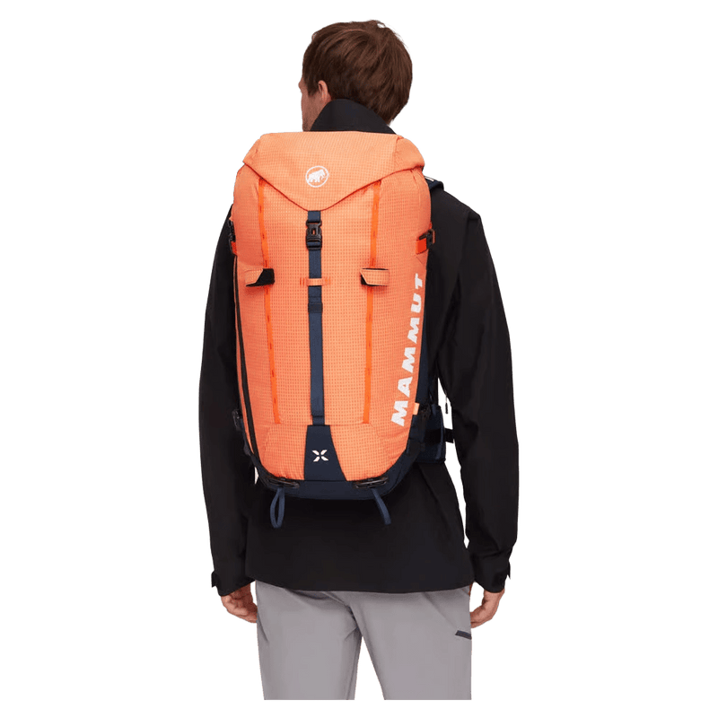 Carried view of the Mamut Trion 38L Backpack in Arumita and Marine colourway, unisex's model