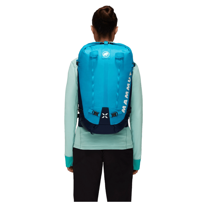 Carried view of the Mamut Trion Nordwand 28L Backpack in Sky and Night colourway, women's model