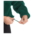 View of a woman wearing The North Face Extreme Pile 2 Pullover for Women in Hunter Green featuring side pockets and an adjustable hem
