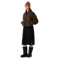 View of a woman wearing The North Face Extreme Pile 2 Pullover for Women in Smokey Brown featuring a half front zip, zip chest pocket, side pockets and adjustable hem, with a small side embroidered logo on the left chest.