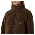 View of a woman wearing The North Face Extreme Pile 2 Pullover for Women in Smokey Brown featuring a zip chest pocket, and a small side embroidered logo on the left chest.