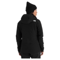 View of a woman wearing The North Face Summit Casaval Hybrid Hoodie in black, showing the back side with a hood and small white logo on the left shoulder.