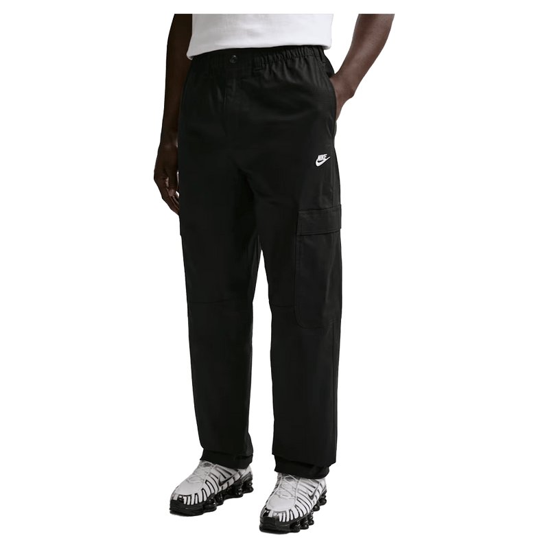 Main view of the Nike Club Cargo Pants in Black colourway, unisex model
