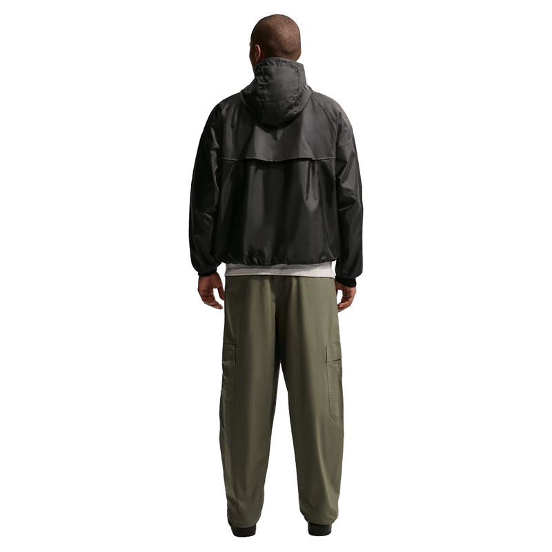 Back view of the Nike Club Cargo Pants in Olive colourway, unisex model