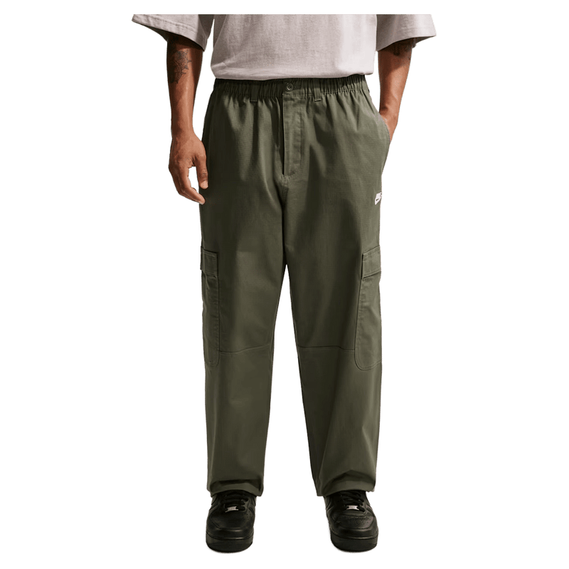 Main view of the Nike Club Cargo Pants in Olive colourway, unisex model