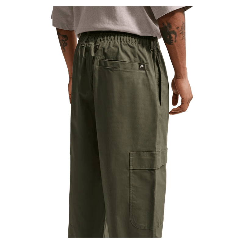 Back view of the Nike Club Cargo Pants in Olive colourway, unisex model