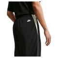 Detail view of the Nike Club Lightweight Pants in Black and Khaki colourway, men model