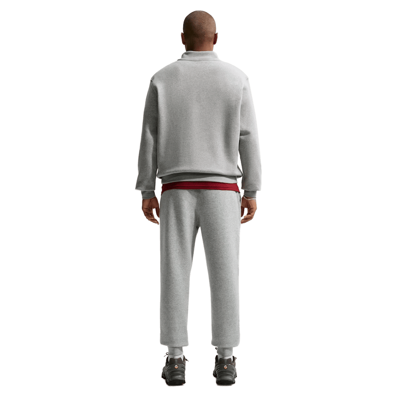 Back view of the Nike Club Track Pants in Dark Grey Heather and light Smoke colourway, unisex model