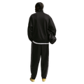 Back view of the Nike Club Track Sweatpants in Black and White colourway, men model