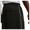 Detail view of the Nike Club Track Sweatpants in Black and White colourway, men model