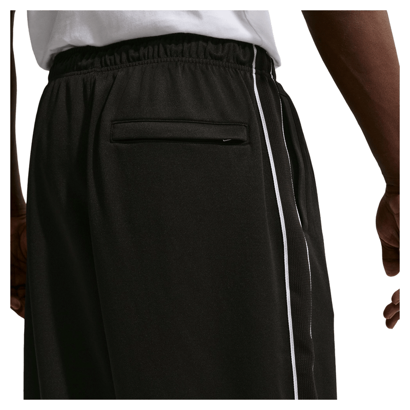 Detail view of the Nike Club Track Sweatpants in Black and White colourway, men model