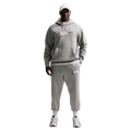 Front view of the Nike Club Track Sweatpants in Dark Grey Heather and light Smoke colourway, men model