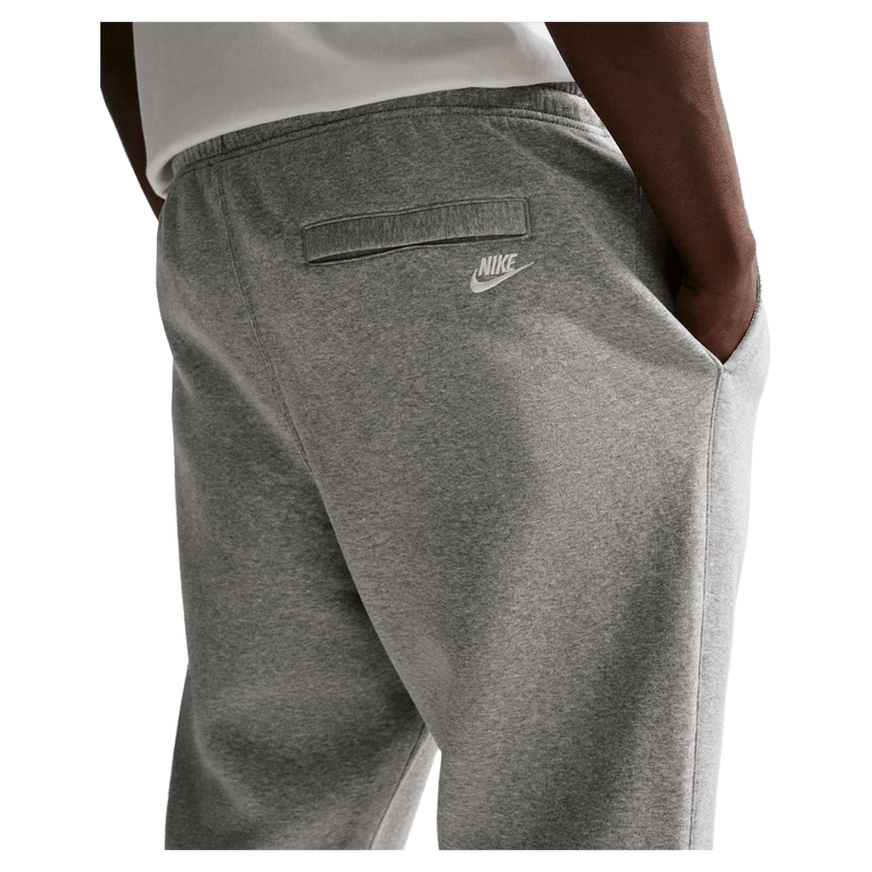 Detail view of the Nike Club Track Sweatpants in Dark Grey Heather and light Smoke colourway, men model